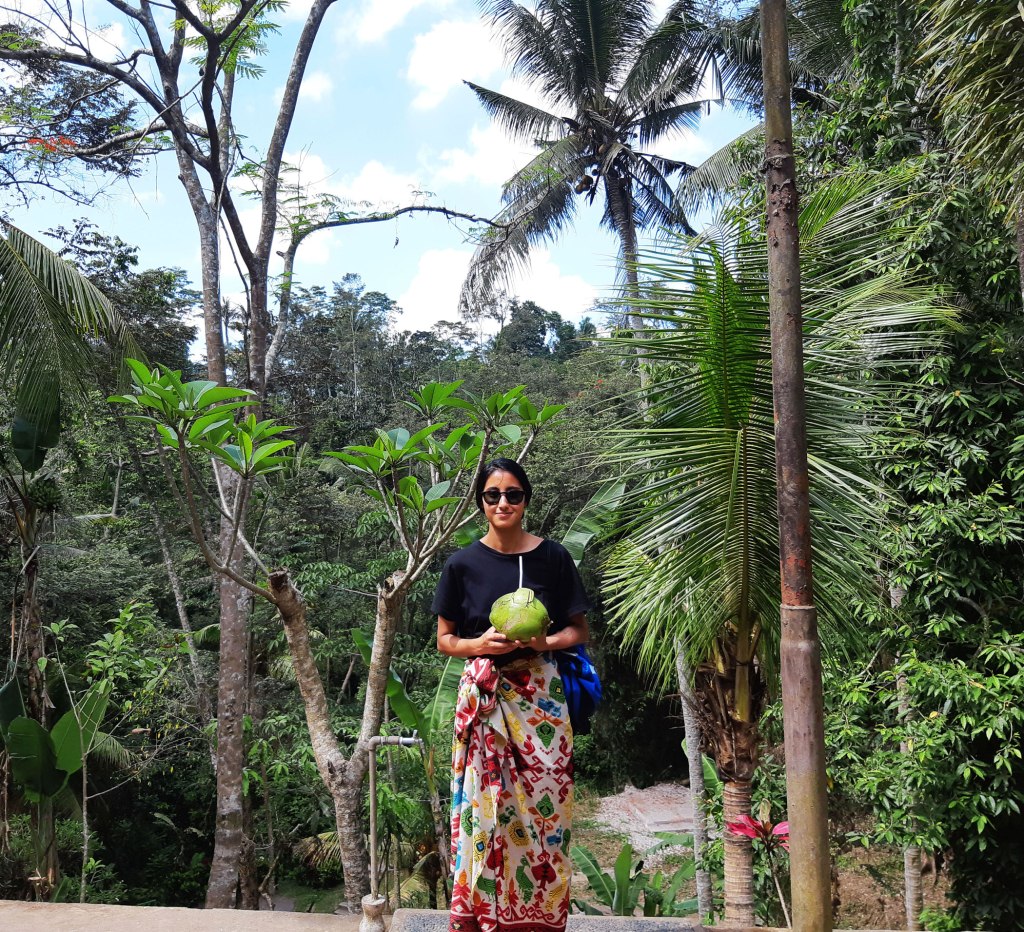 Re-hydrating with a coconut in Goa Gajah, Bali, Indonesia.