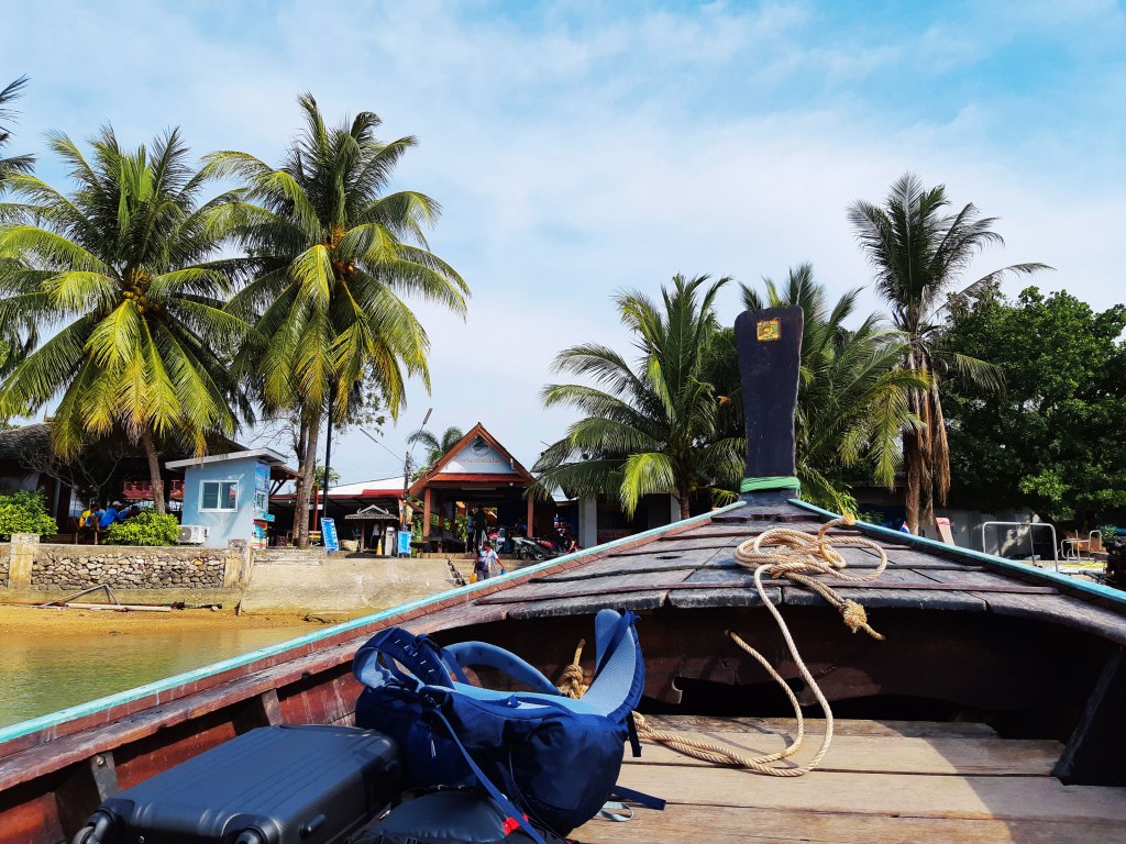 Taking a long boat from the pier to the resort. Krabi, Thailand.