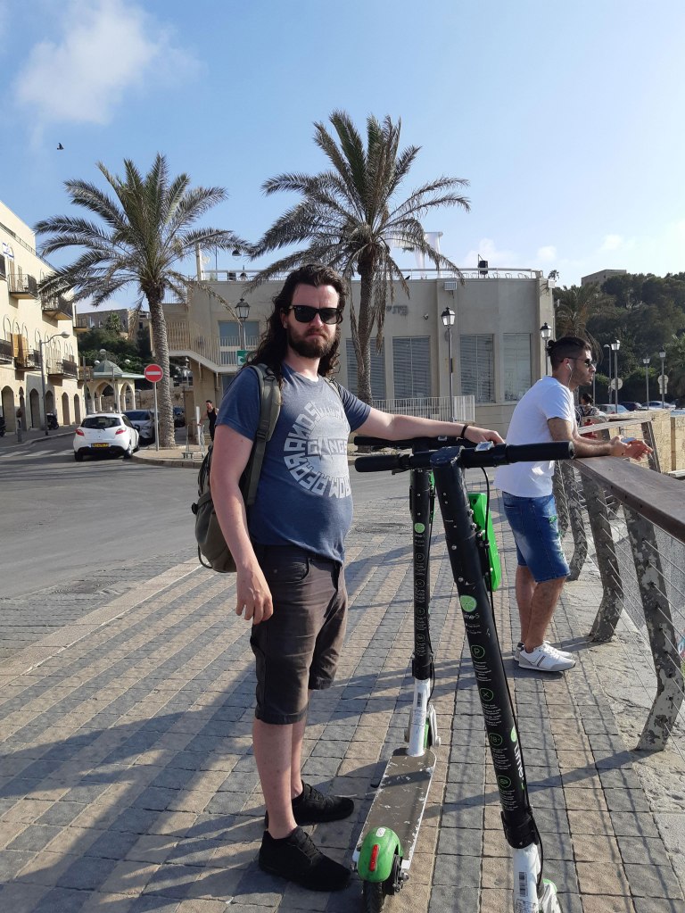 Riding Scooters around the Tel Aviv Boardwalk, Israel.