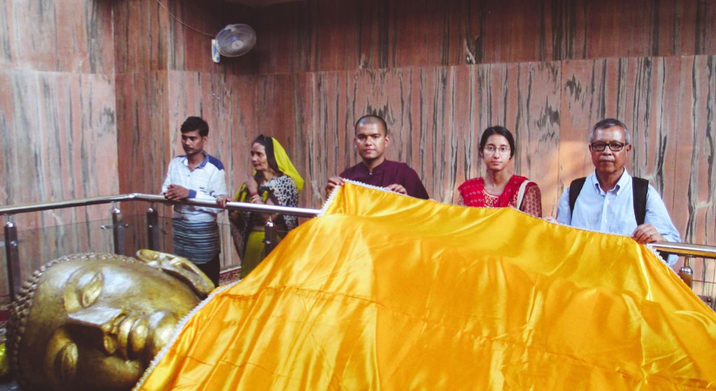 Robe offering to the reclining Buddha, Kushinaga, Uttar Pradesh, India.